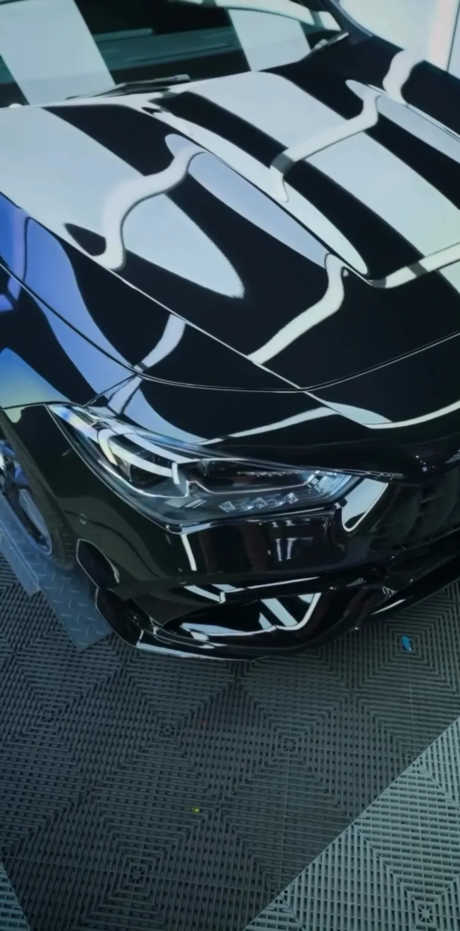 Light reflections running across a black Mercedes-AMG