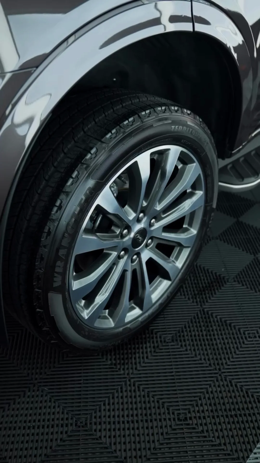 Clean alloy wheel and wheel arch on a dark SUV
